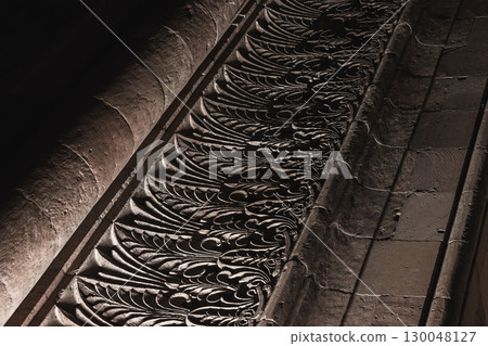 Close-up view of beautifully detailed architectural carvings displayed on a wall Close-up view of beautifully detailed architectural carvings displayed on a wall 130048127