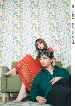 A young couple relaxing on the sofa 130048301