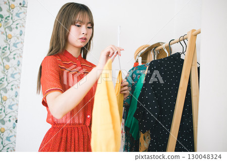 A woman choosing clothes A woman choosing clothes 130048324