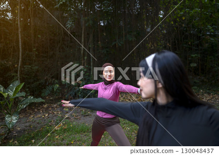 Indonesian southeast asian women in a sporty outfit practice exercise in a public park outdoors. Concept of a Healthy active lifestyle 130048437