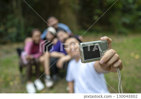 Indonesian southeast asian people in a sporty outfit taking a selfie with a camera together after practice exercise in a public park outdoors. Concept of a Healthy active lifestyle 130048802