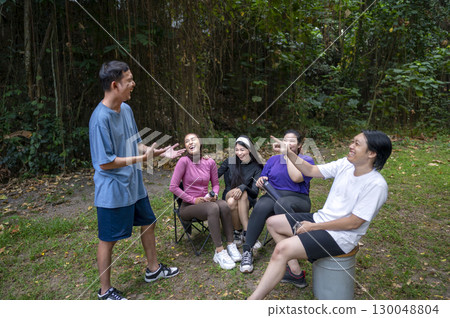 Indonesian southeast asian people in a sporty outfit conversation or discussion together after practice exercise in a public park outdoors. Concept of a Healthy active lifestyle Indonesian southeast asian people in a sporty outfit conversation or discussion together after practice exercise in a public park outdoors. Concept of a Healthy active lifestyle 130048804
