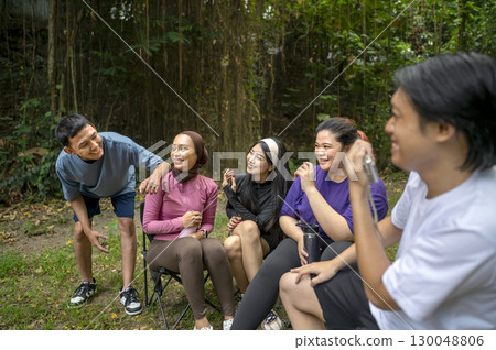 Indonesian southeast asian people in a sporty outfit conversation or discussion together after practice exercise in a public park outdoors. Concept of a Healthy active lifestyle Indonesian southeast asian people in a sporty outfit conversation or discussion together after practice exercise in a public park outdoors. Concept of a Healthy active lifestyle 130048806