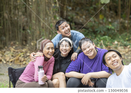 Indonesian southeast asian people in a sporty outfit taking a selfie together after practice exercise in a public park outdoors. Concept of a Healthy active lifestyle 130049036