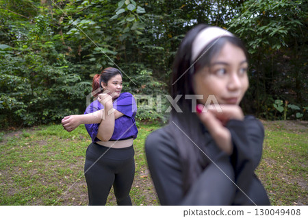 Indonesian southeast asian women in a sporty outfit practice exercise in a public park outdoors. Concept of a Healthy active lifestyle Indonesian southeast asian women in a sporty outfit practice exercise in a public park outdoors. Concept of a Healthy active lifestyle 130049408