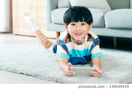 Boy playing with a smartphone 130049439