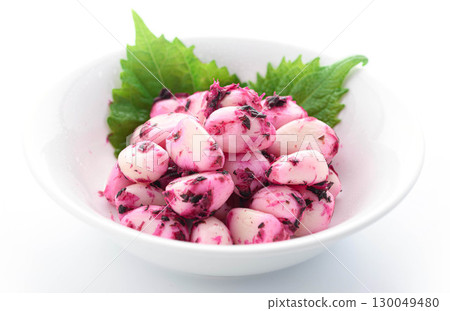 A Japanese food image of shiso, bonito, garlic, and white rice against a white background. Food photo perfect as a side dish or snack with rice. 130049480