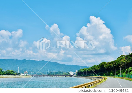 Summer cumulonimbus clouds at the mouth of a river 130049481