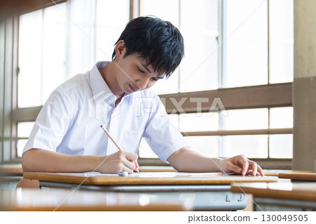 Boys studying to study 130049505