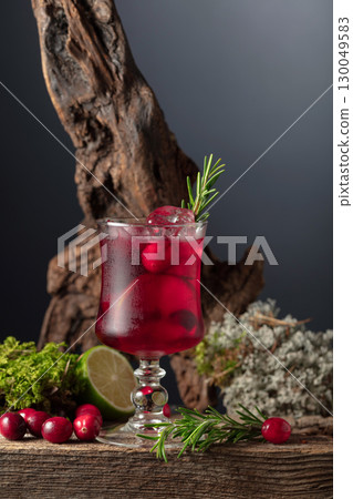 Refreshing cranberry hard seltzer with lime, rosemary, and ice. 130049583