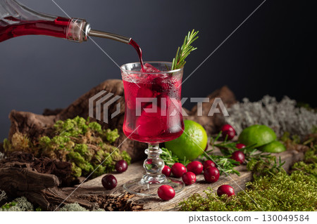 Refreshing cranberry hard seltzer with lime, rosemary, and ice. 130049584