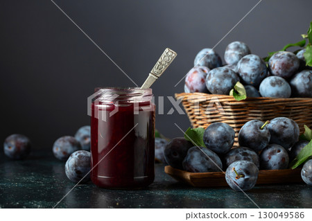 Ripe plums with jam on the kitchen table. Ripe plums with jam on the kitchen table. 130049586