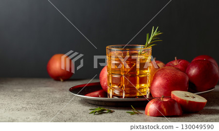 Apple juice and fresh apples on an old kitchen table. 130049590