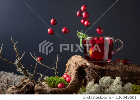 Hot drink with cranberries, lime, and rosemary. 130049601