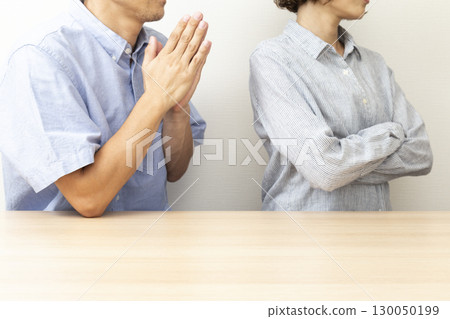Husband apologizing to his wife on white background 130050199