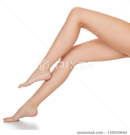 Beautiful long female legs, unwanted hair removal concept. Skin care. White background, isolated 130050644