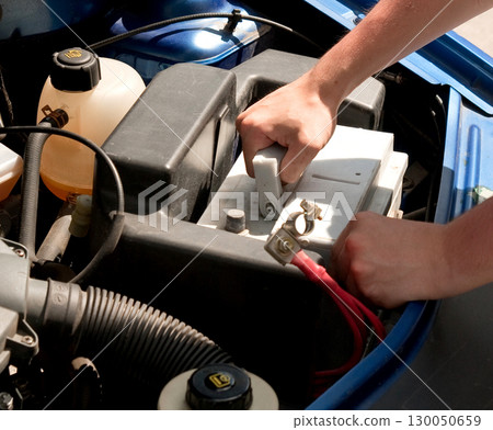 Mechanic changing car battery, closeup shot 130050659