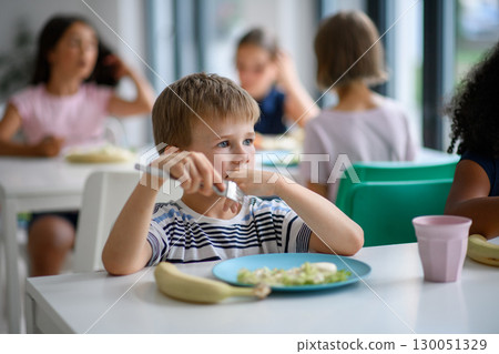 Kids in school eating in canteen, having healthy lunch. 130051329