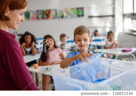 Young children learning about sustainability and ecology, sorting waste. 130051330
