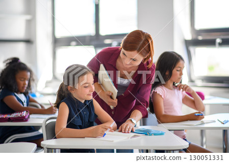 Teacher talking with children in primary class. 130051331