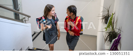 Girl friends talking in school hallway. Banner with copy space. Girl friends talking in school hallway. Banner with copy space. 130051351