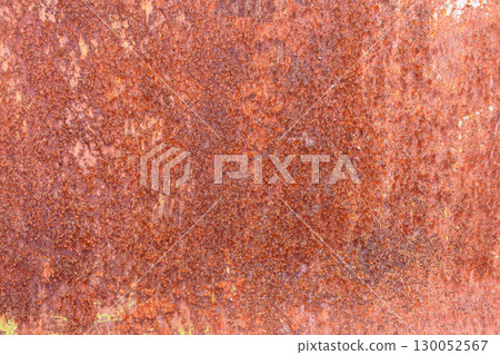 Red-brown texture of metal sheet.Completely rusted sheet metal.Metal corrosion.Rust texture close up. 130052567