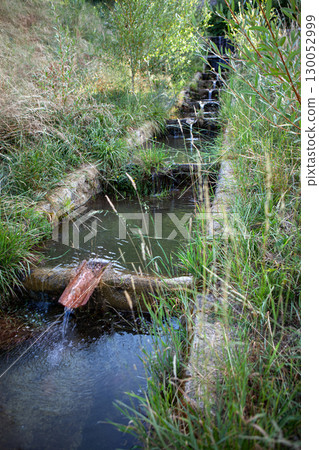 Flow of mountain water into meadows Flow of mountain water into meadows 130052999