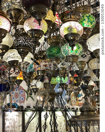Colorful mosaic lanterns hanging in market with intricate patterns, creating vibrant background 130053049