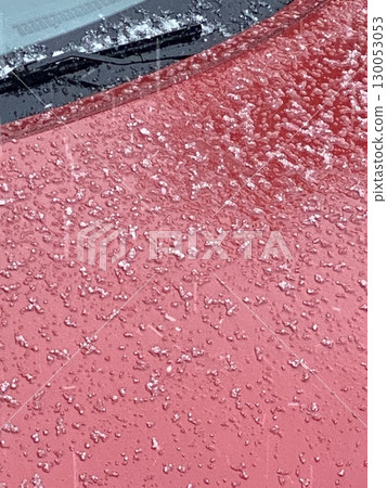 Frozen ice crystals on red car surface creating wintery abstract background Frozen ice crystals on red car surface creating wintery abstract background 130053053