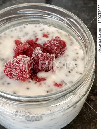 Frozen raspberries and chia seeds in yogurt overhead shot, ideal for food background use 130053055