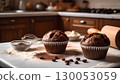 Dark brown muffins, cocoa powder and coffee beans on a table in the kitchen, selective focus. 130053059