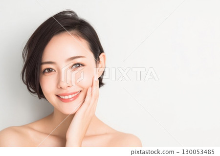 A woman with a smile at the camera's eyes 130053485