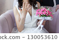 The bride shows the ring on his finger and smiles. a bouquet of flowers 130053610
