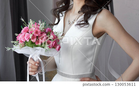 Bride with a bouquet of flowers in a white dress 130053611