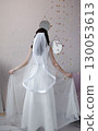 Bride in a white dress with a veil look from the back 130053613