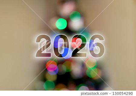 festive image of the number 2026 with a beautiful bokeh effect. a blurred Christmas tree in the background. New Year 2026 bokeh background. festive bokeh Christmas tree 130054290