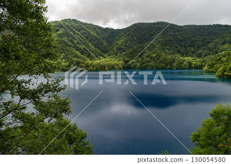 The beautiful blue surface of Onuma Pond in Shiga Kogen 130054580