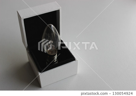 Candle Bulb In A Jewelry Box Isolated On White Surface Copy Space Image 130054924