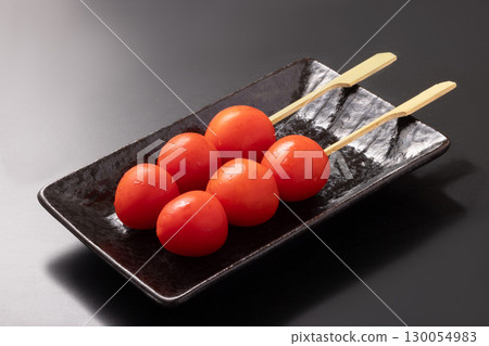 Cherry tomato skewers (before cooking) Cherry tomato skewers (before cooking) 130054983