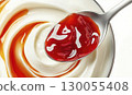Yogurt with berry jam on spoon, isolated on white background, package design element 130055408