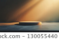 Round pedestal mockup on rocky surface with warm sunlight with copy space 130055440
