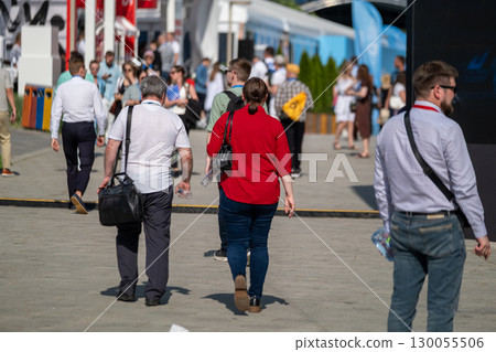 Outdoor business event with people walking on a sunny day 130055506