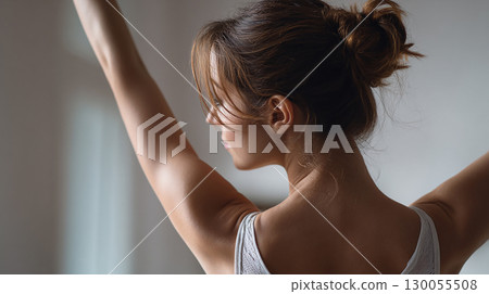 Focused Ballet Dancer Practicing Graceful Arm Movement in Studio 130055508