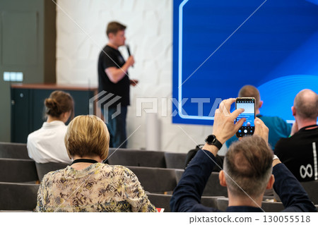Speaker giving a presentation in a seminar with an engaged audience Speaker giving a presentation in a seminar with an engaged audience 130055518