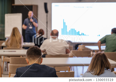 Speaker presenting data to attentive audience during business seminar 130055519