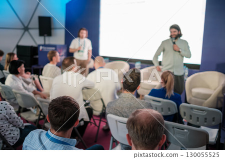 Group engaging in conference or workshop presentation in modern professional atmosphere Group engaging in conference or workshop presentation in modern professional atmosphere 130055525