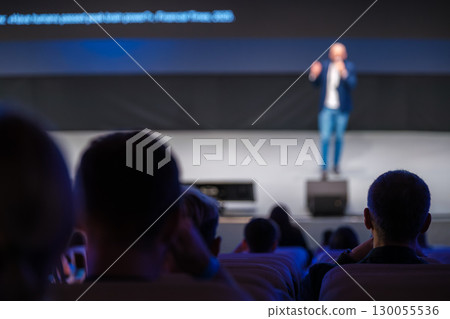 Speaker giving a talk on stage during a business presentation Speaker giving a talk on stage during a business presentation 130055536