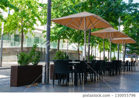 Cafe on the open air. Chairs and tables outside on the summer sun weather in Spain. Design of furnitureset for summer cafe or restaurant. Cafe on the open air. Chairs and tables outside on the summer sun weather in Spain. Design of furnitureset for summer cafe or restaurant. 130055796