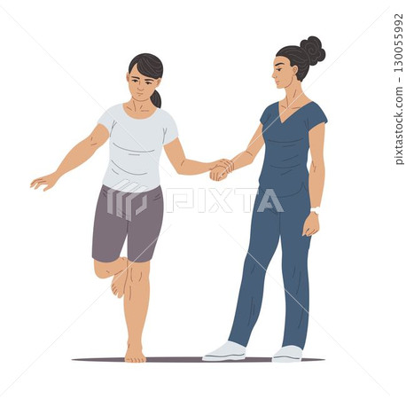 Physiotherapist helps woman balance exercise standing on one leg 130055992