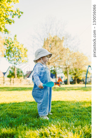 Adorable Toddler in a Park A Beautiful Moment of Pure Childhood Innocence Captured Under Bright and Clear Blue Skies, Surrounded by Lush Nature and the Joy of Playfulness and Adventure Adorable Toddler in a Park A Beautiful Moment of Pure Childhood Innocence Captured Under Bright and Clear Blue Skies, Surrounded by Lush Nature and the Joy of Playfulness and Adventure 130056066